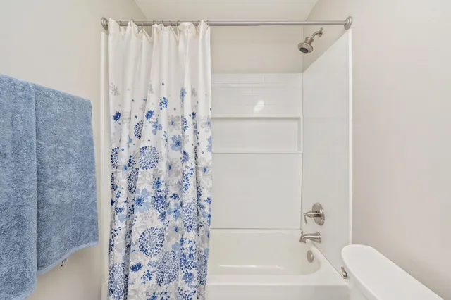a bathroom with a shower curtain and a bathtub