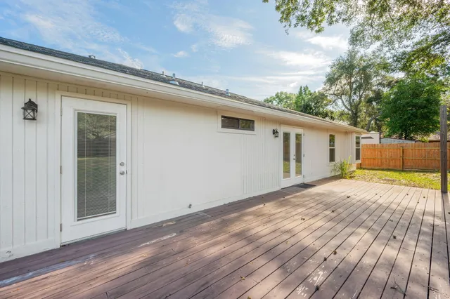 a view of a house with a wooden deck