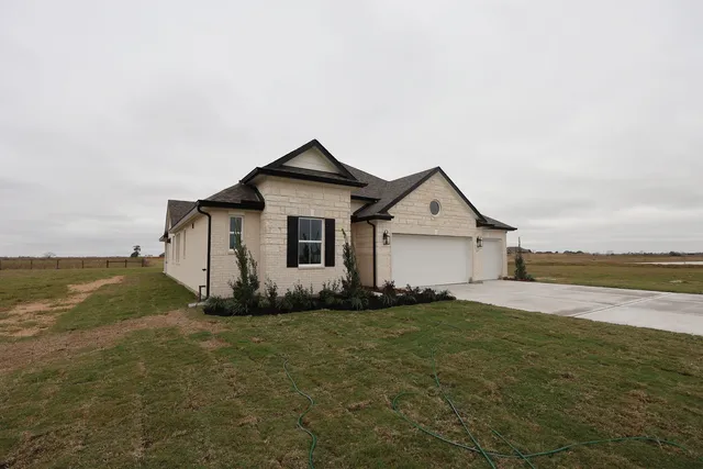 a view of a house with a yard and large window