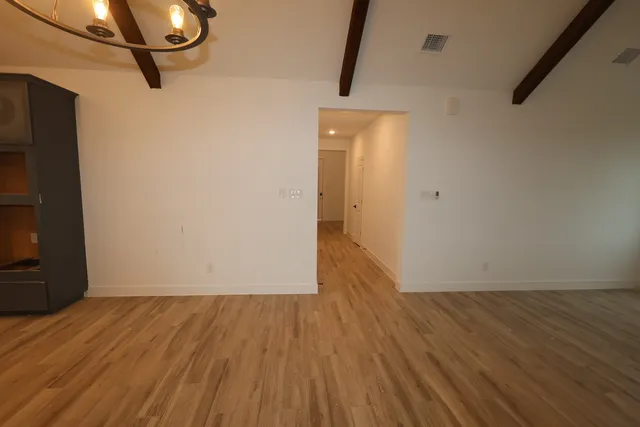 a view of a room with wooden floor