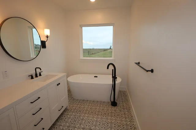a bathroom with a sink a toilet and a mirror