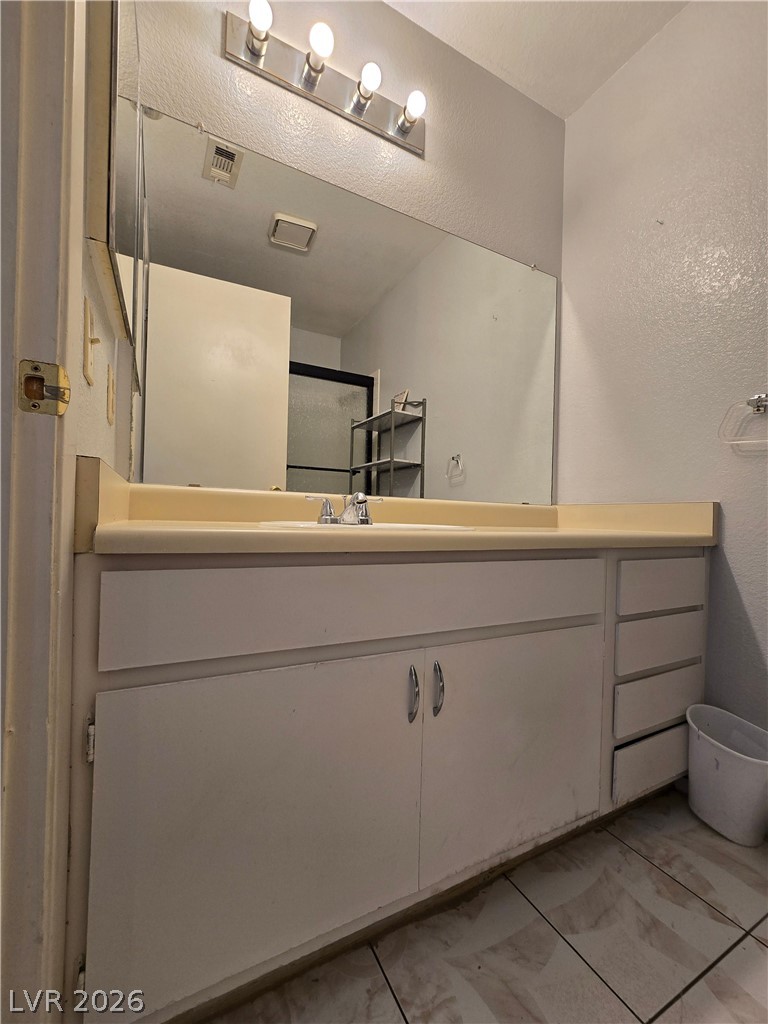 6750 Del Rey Avenue, Unit 133 Las Vegas, NV 89146 - Photo 26 of 34 A well-appointed vanity with generous counter space awaits in this functional bathroom.
