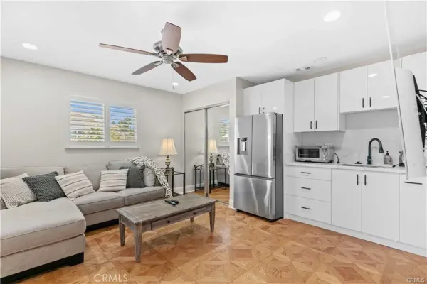 a living room with furniture and kitchen view