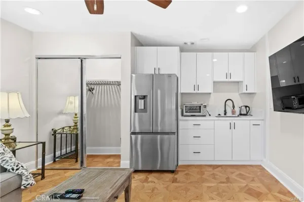 a kitchen with stainless steel appliances granite countertop a refrigerator sink and cabinets
