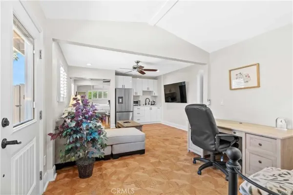 a view of a livingroom with workspace and a couch
