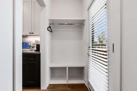 a view of walk in closet and bedroom