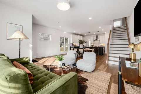 a living room with furniture and wooden floor