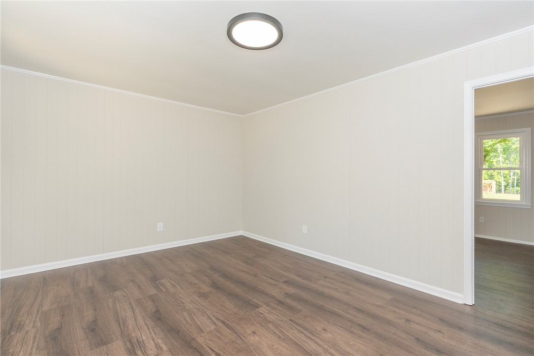113 Linda Lane Honea Path, SC 29654 - Photo 6 of 36 This versatile room features durable flooring and ample natural light, ideal for various uses.