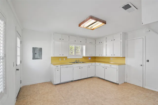 a spacious bathroom with stainless steel appliances granite countertop a sink and dishwasher