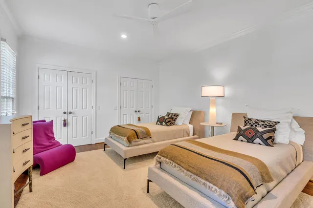 a bedroom with two bed and a couch