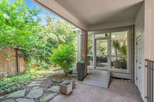 a view of a porch with furniture and floor to ceiling window