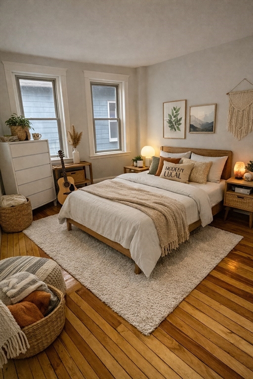 108 Bristol Road, Unit 1 Somerville, MA 02144 - Photo 16 of 24 a bedroom with a bed and wooden floor