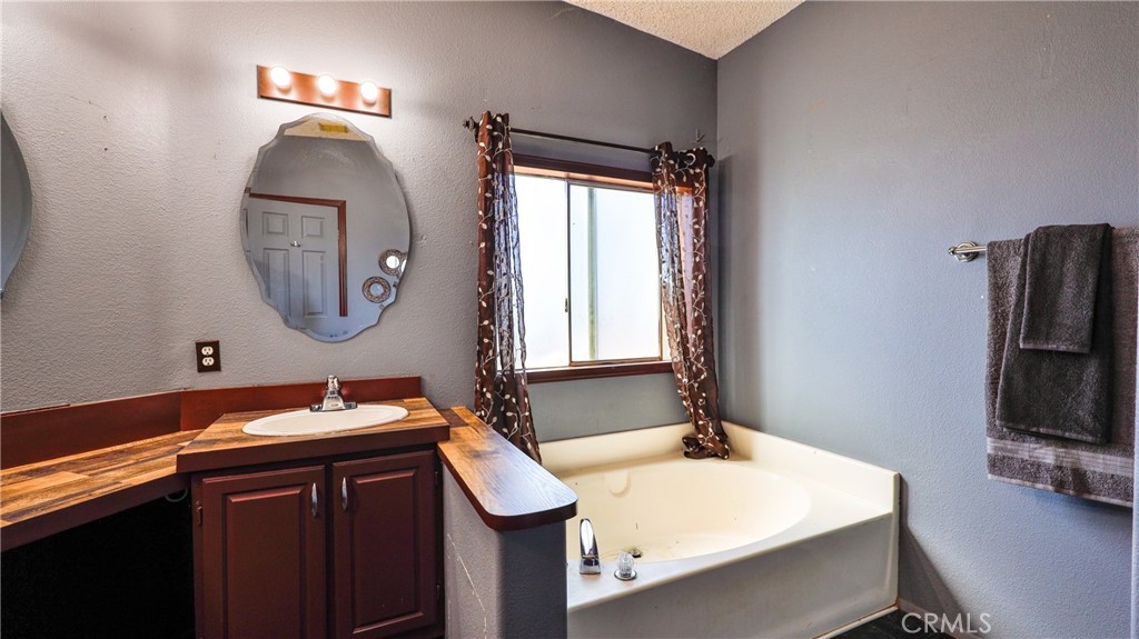 39550 Kirby Road Anza, CA 92539 - Photo 30 of 53 a bedroom with a bed and a mirror