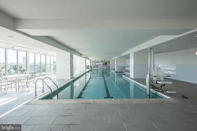 a kitchen with stainless steel appliances granite countertop a kitchen island a stove a table and chairs in it