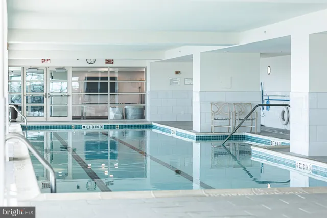 a living room with a floor to ceiling windows and a table