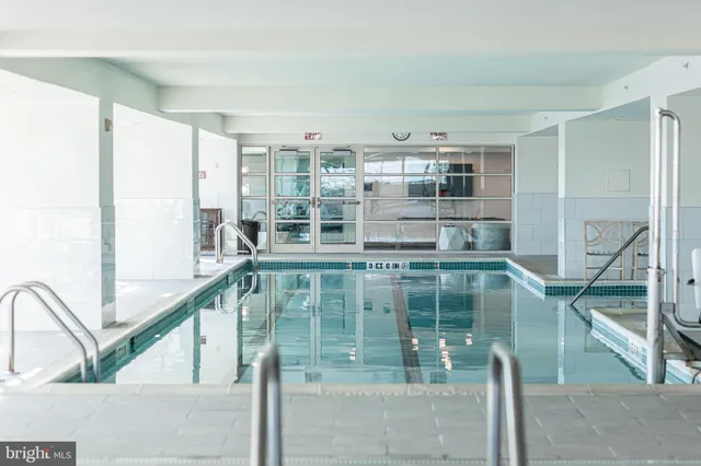 a view of a kitchen counter top space with sink and windows