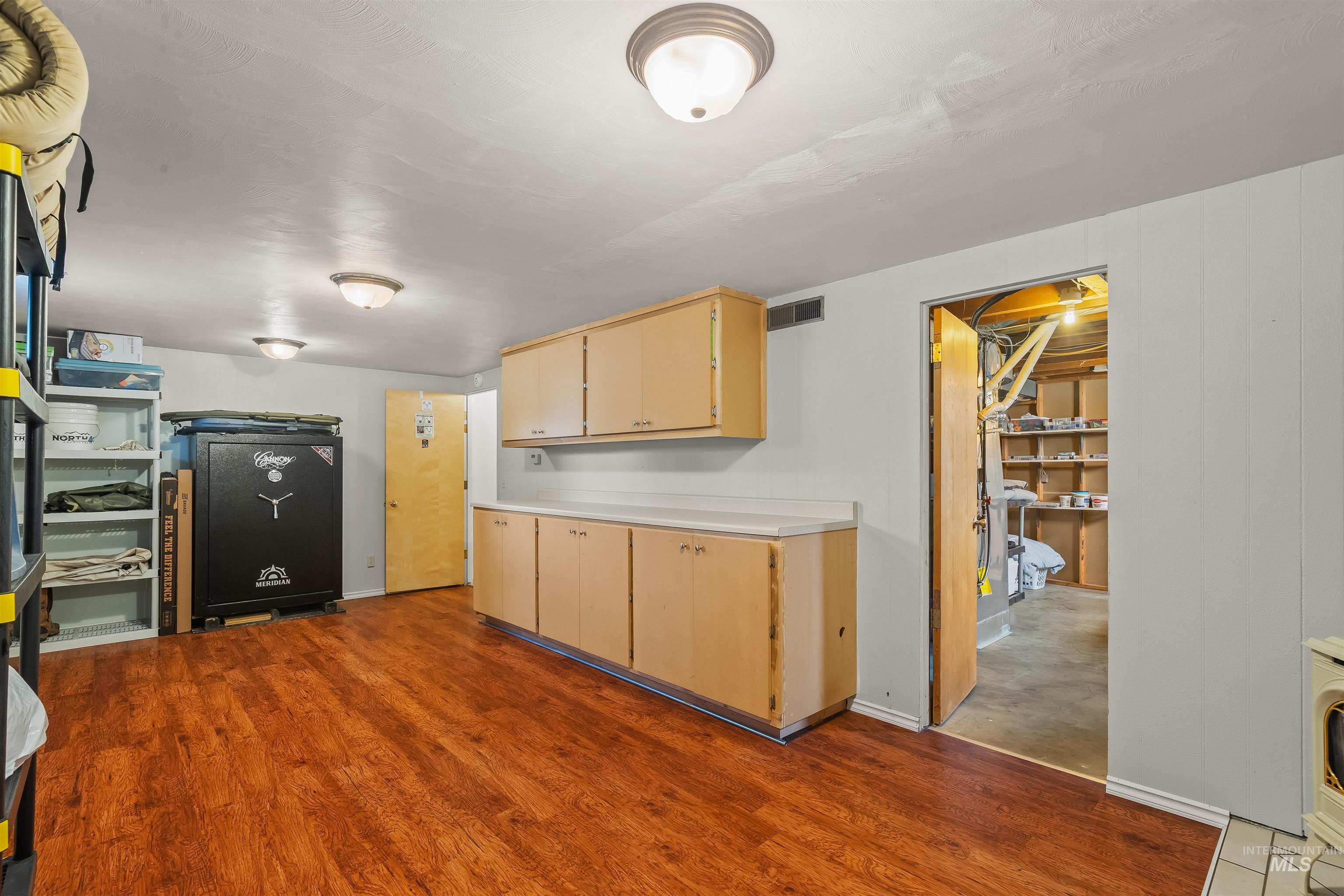 3620 18th Street Lewiston, ID 83501 - Photo 23 of 32 Utility space featuring wood-finish flooring, white panel walls, and multiple ceiling-mounted light fixtures