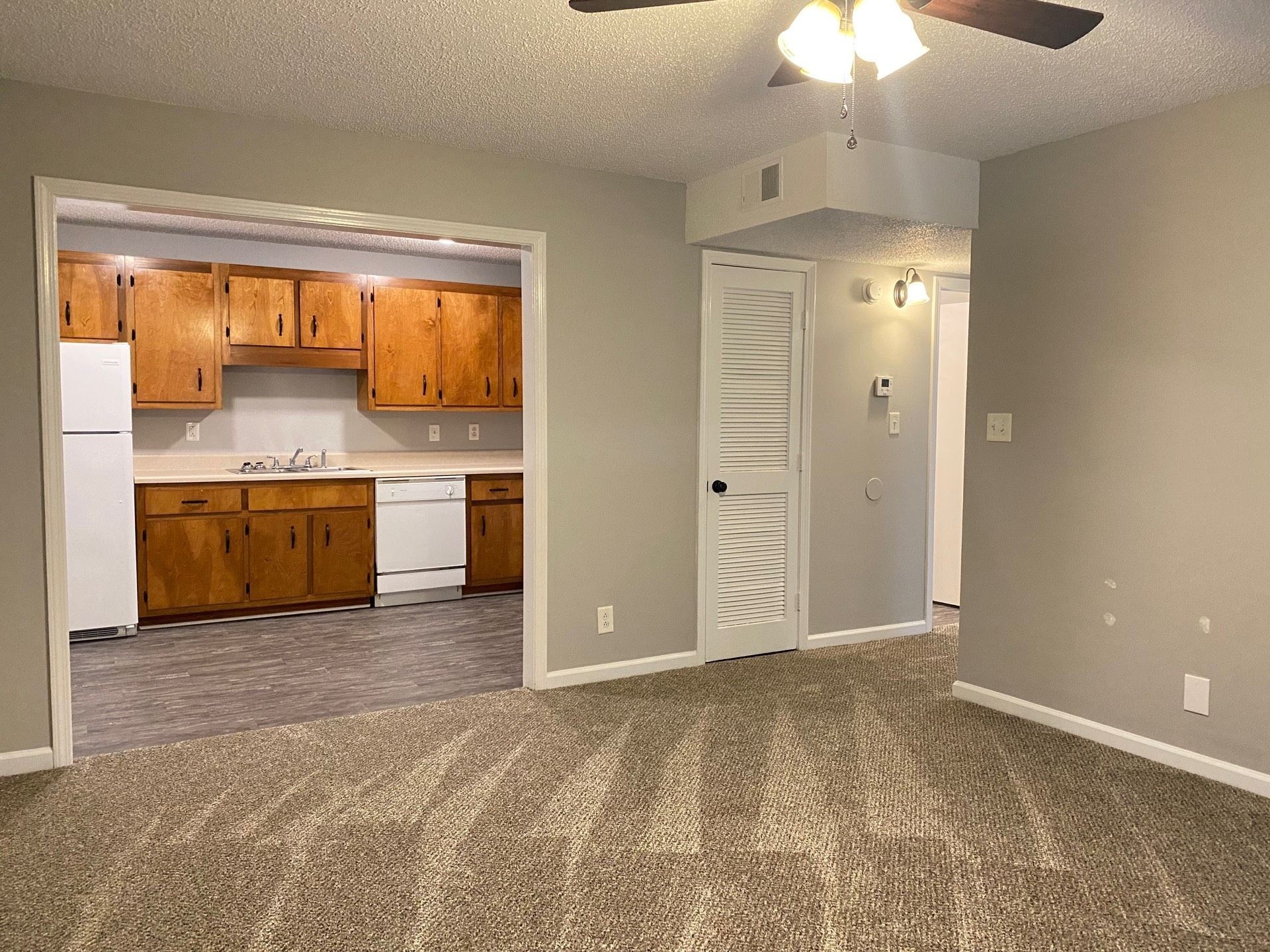 421 Alma Lane, Unit F Clarksville, TN 37043 - Photo 4 of 12 an empty room with a fireplace and chandelier fan