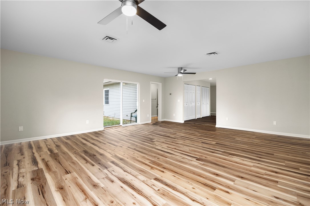 12452 Island Road Grafton, OH 44044 - Photo 11 of 39 Empty room featuring ceiling fan and light wood-style flooring