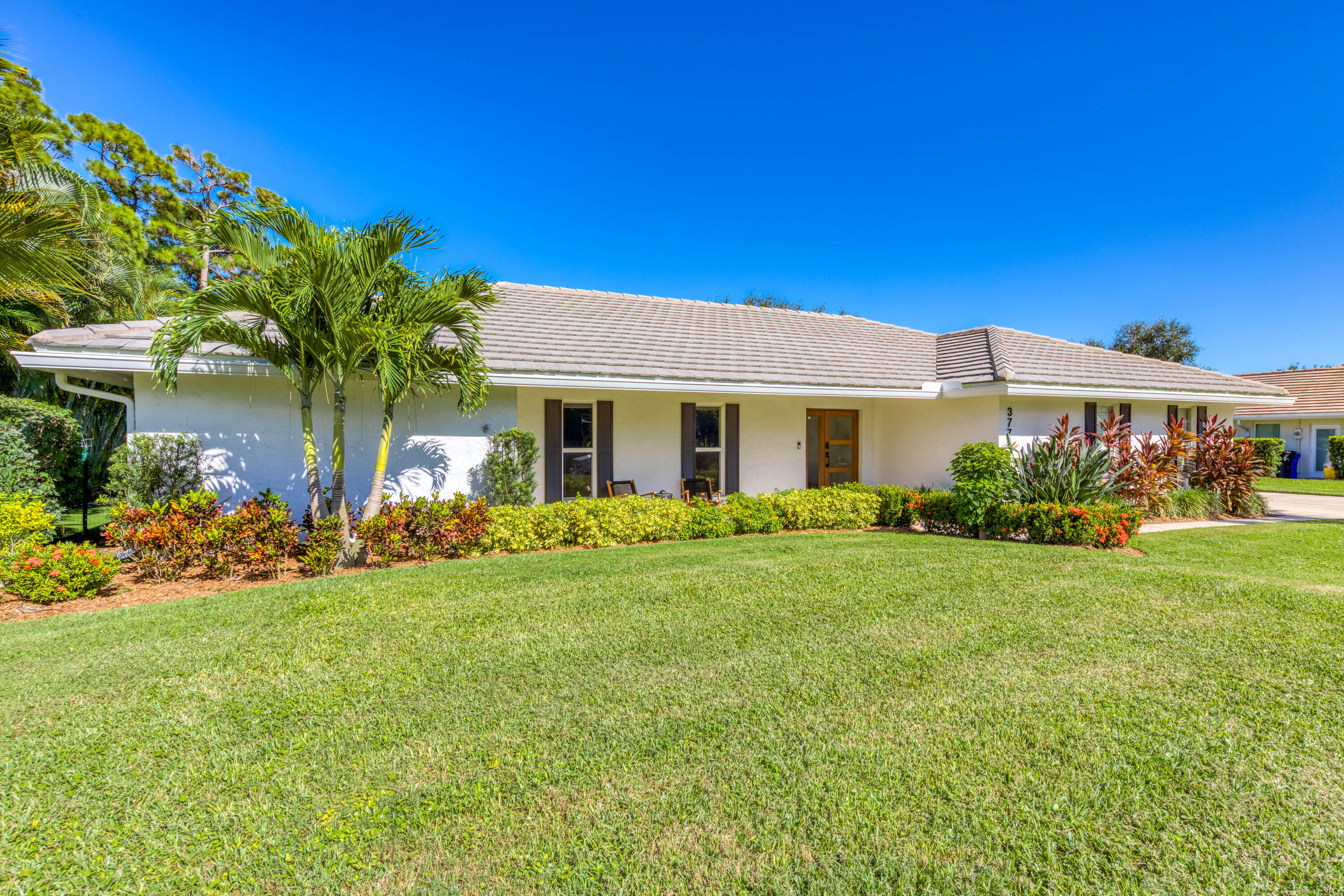 3771 Southeast Fairway West Stuart, FL 34997 - Photo 11 of 41 a front view of a house with garden