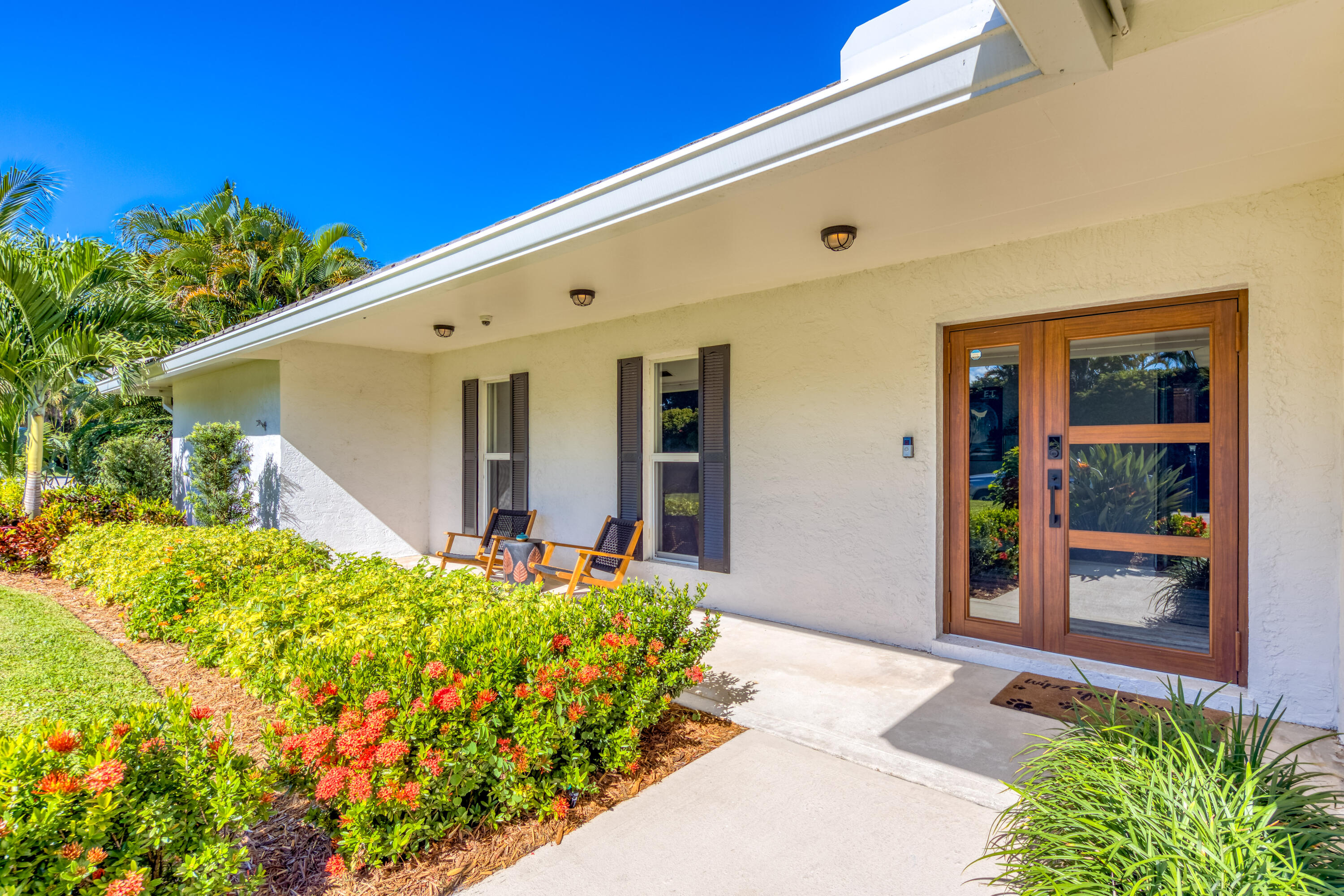3771 Southeast Fairway West Stuart, FL 34997 - Photo 15 of 41 a front view of a house with a yard