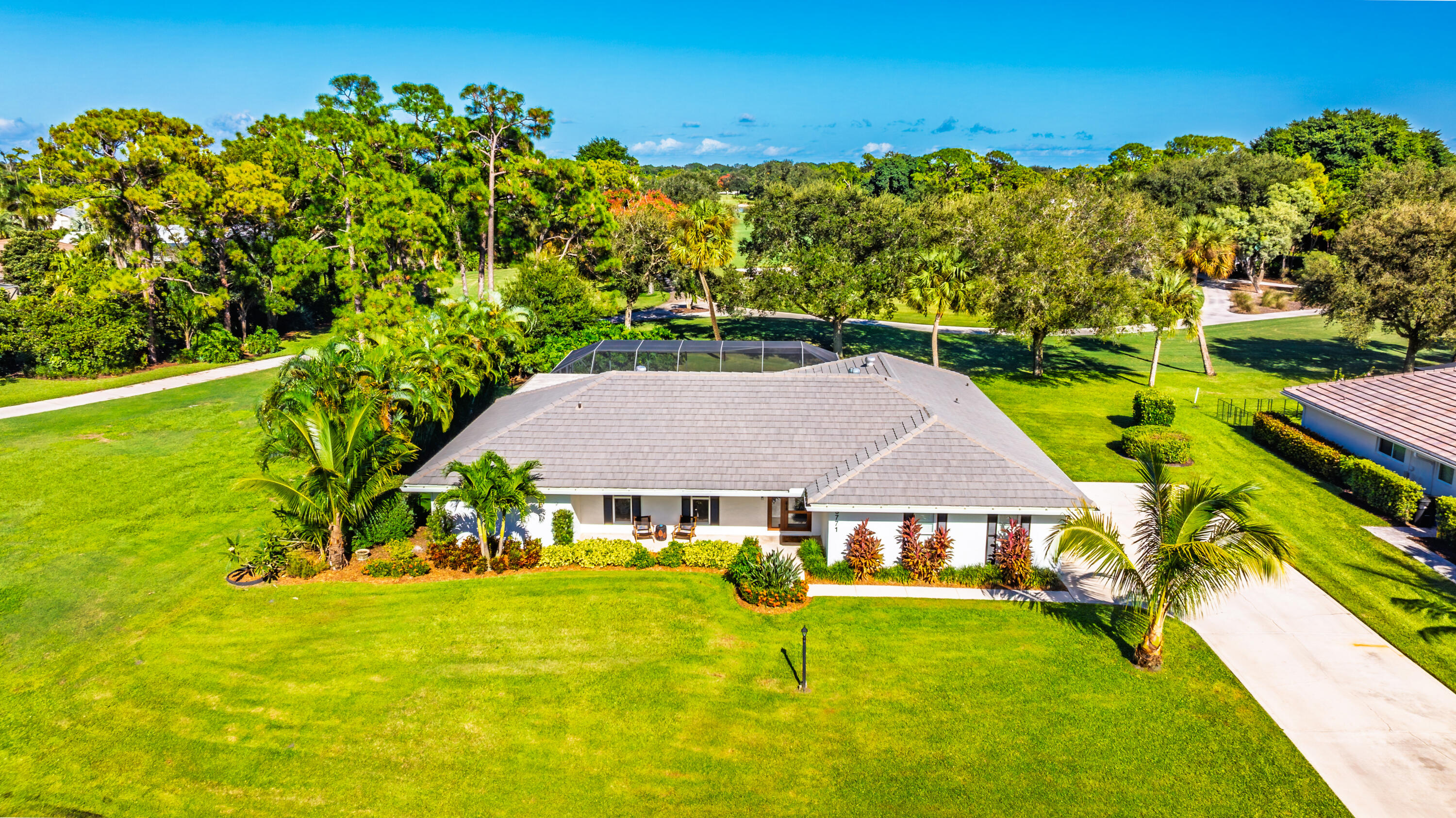 3771 Southeast Fairway West Stuart, FL 34997 - Photo 2 of 41 a view of a house with pool and a yard