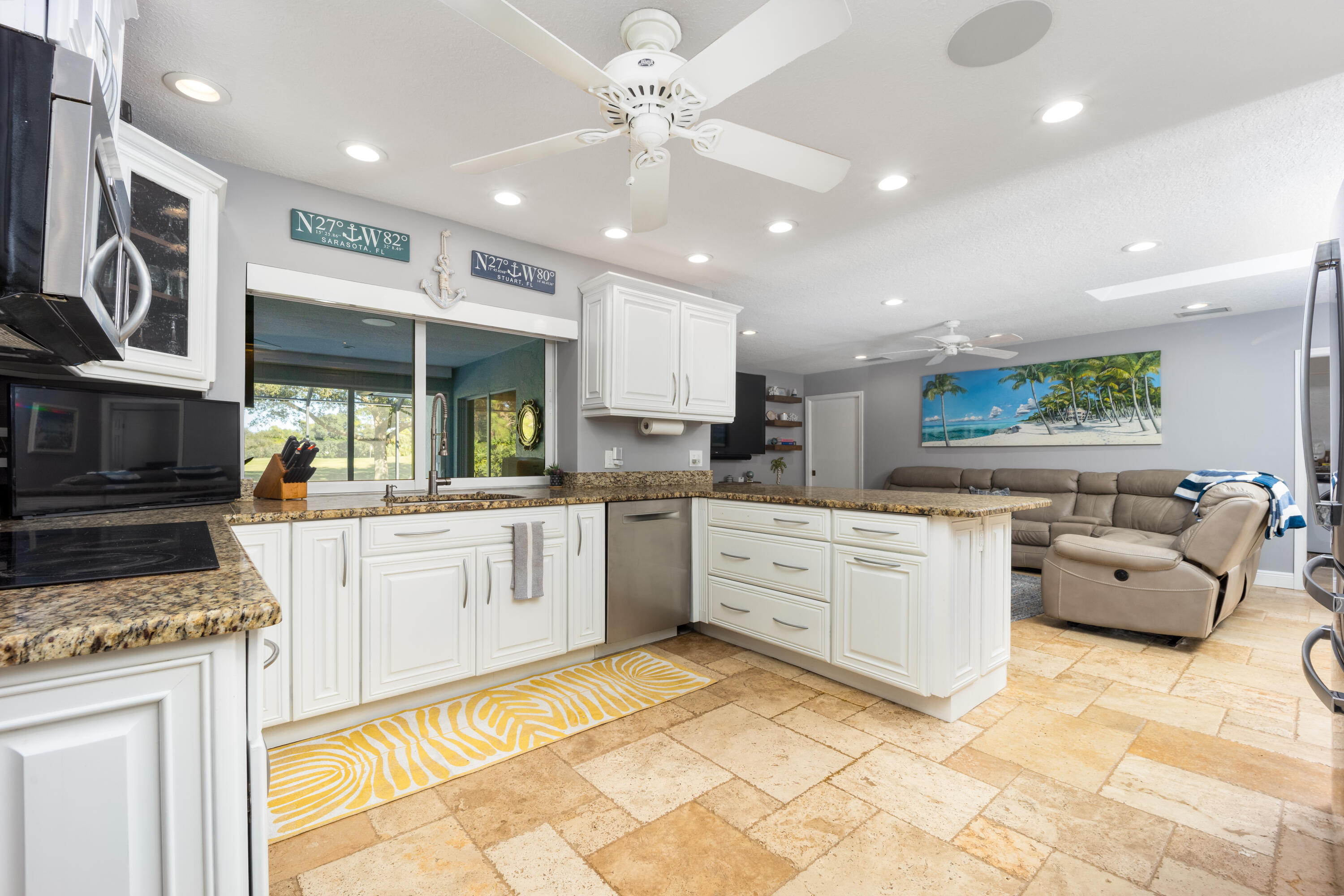3771 Southeast Fairway West Stuart, FL 34997 - Photo 21 of 41 a kitchen with stainless steel appliances granite countertop a stove a sink and a refrigerator