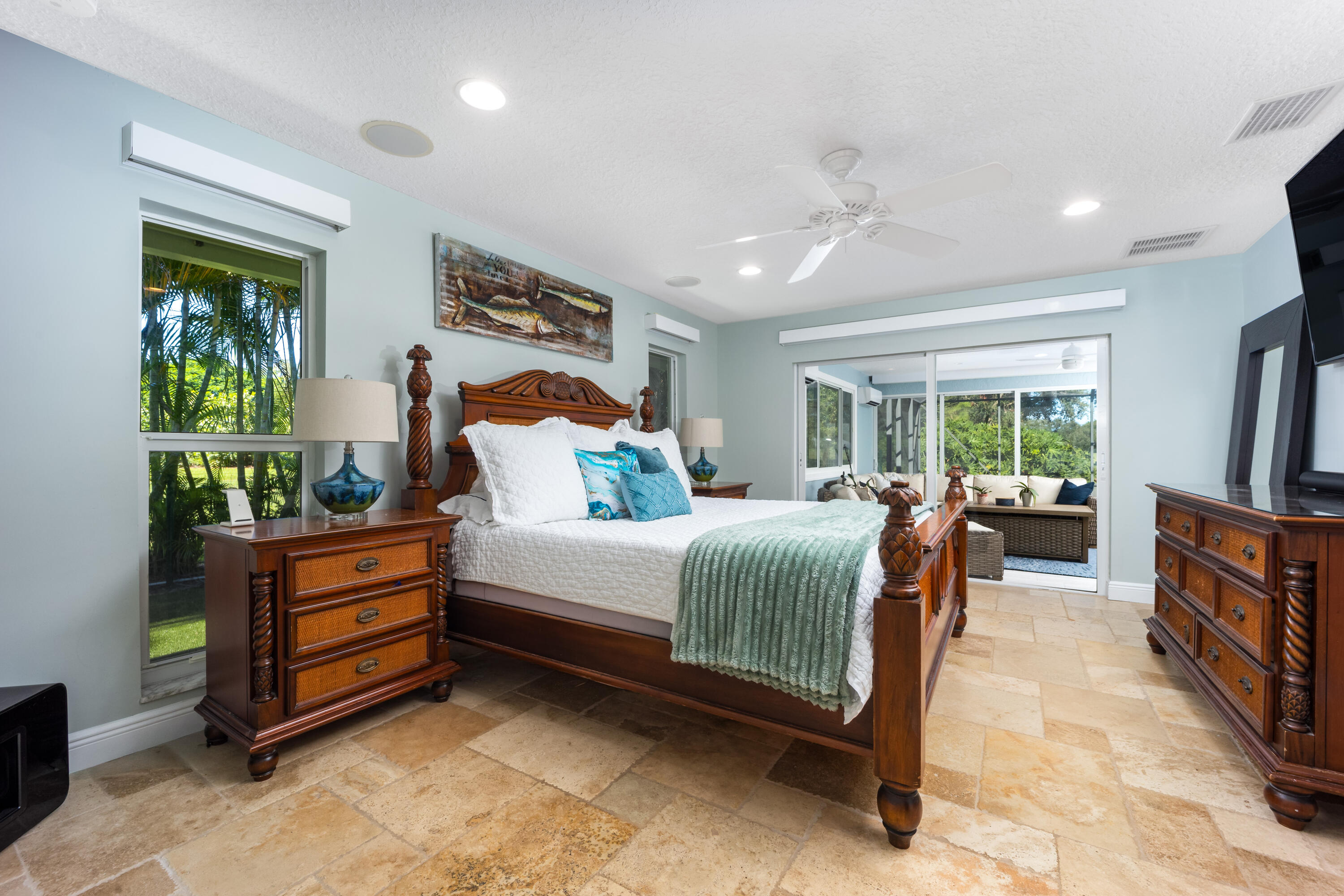 3771 Southeast Fairway West Stuart, FL 34997 - Photo 23 of 41 a bedroom with a bed and a flat tv screen