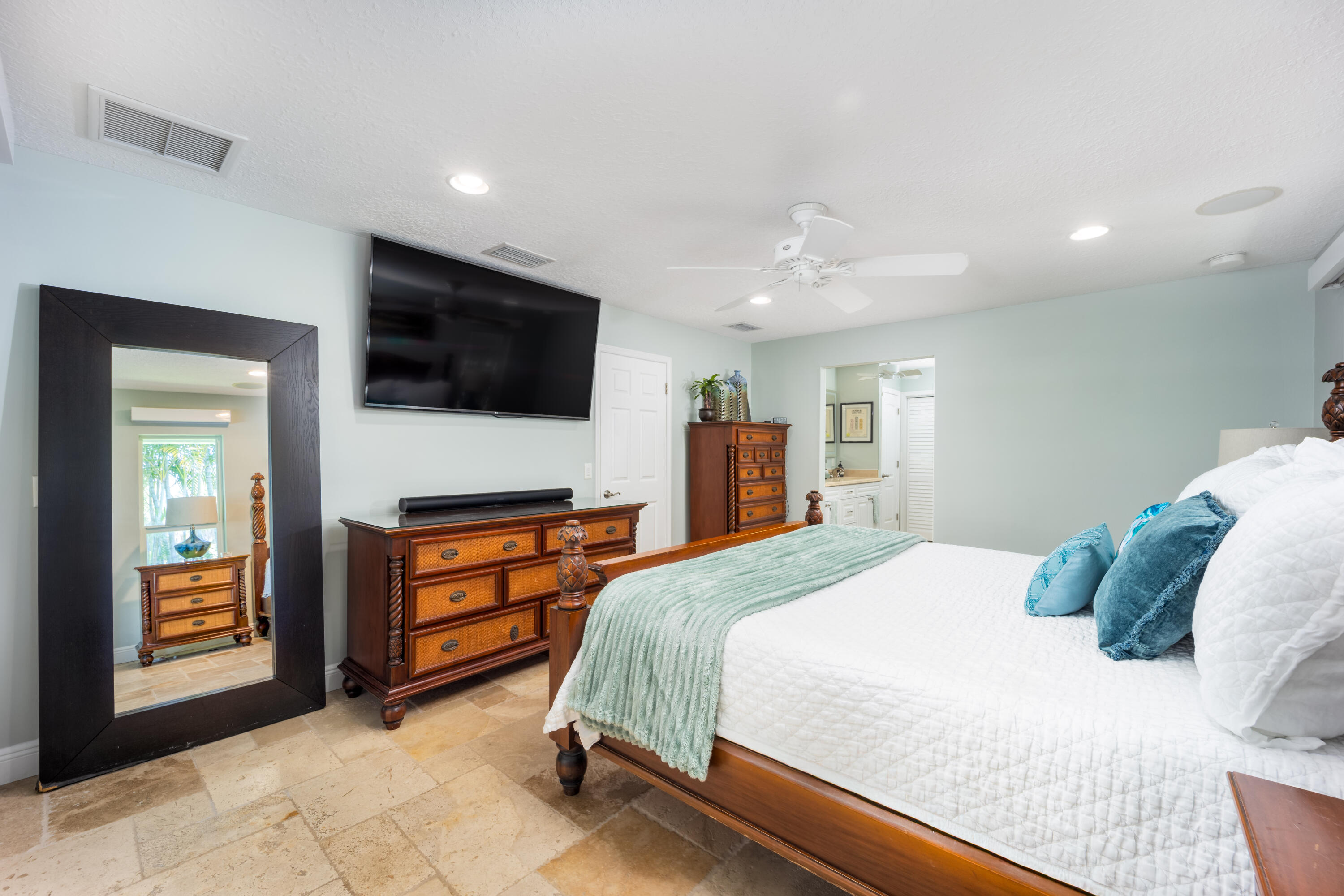 3771 Southeast Fairway West Stuart, FL 34997 - Photo 24 of 41 a bedroom with a bed and a flat screen tv