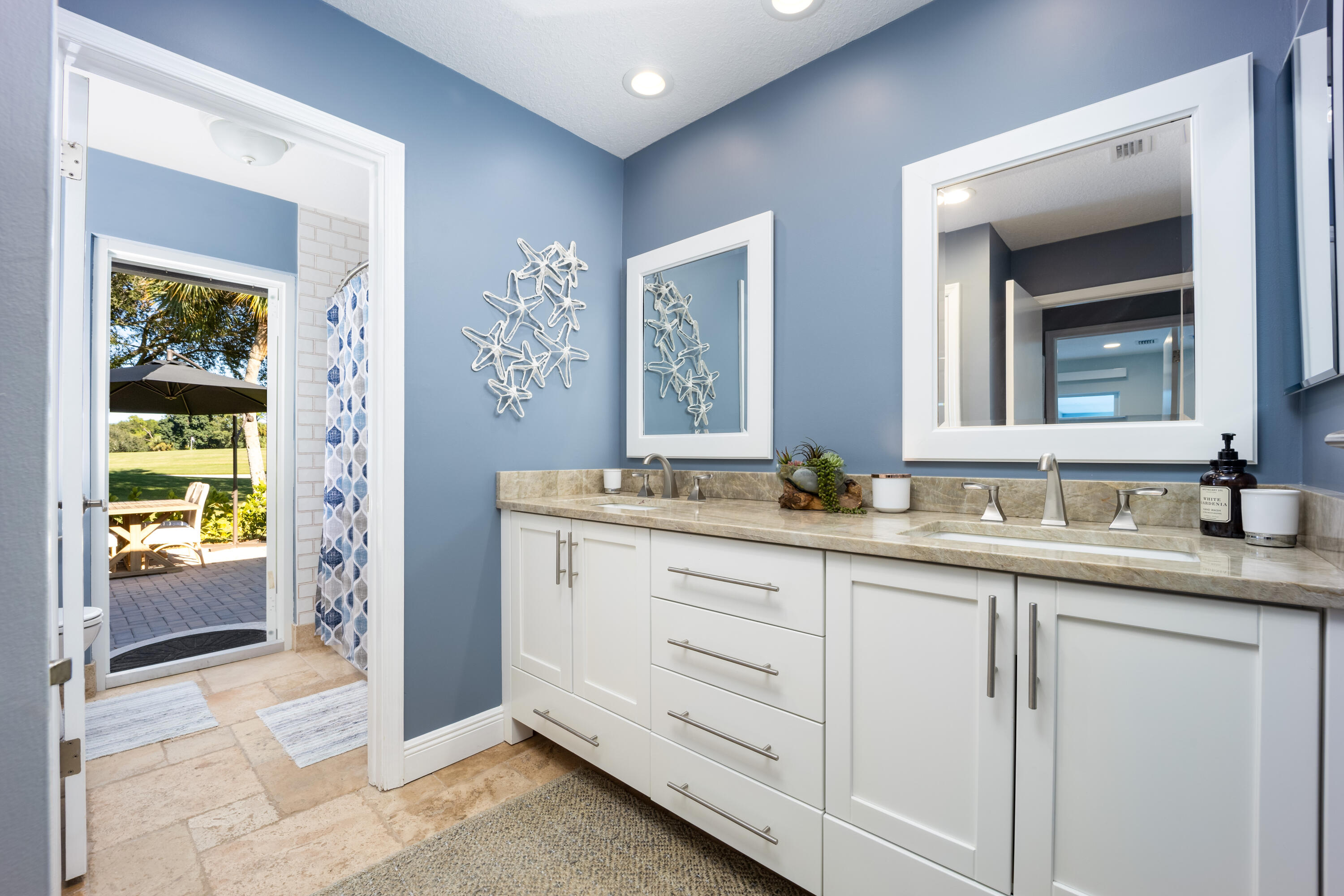 3771 Southeast Fairway West Stuart, FL 34997 - Photo 28 of 41 a bathroom with double sink and a mirror