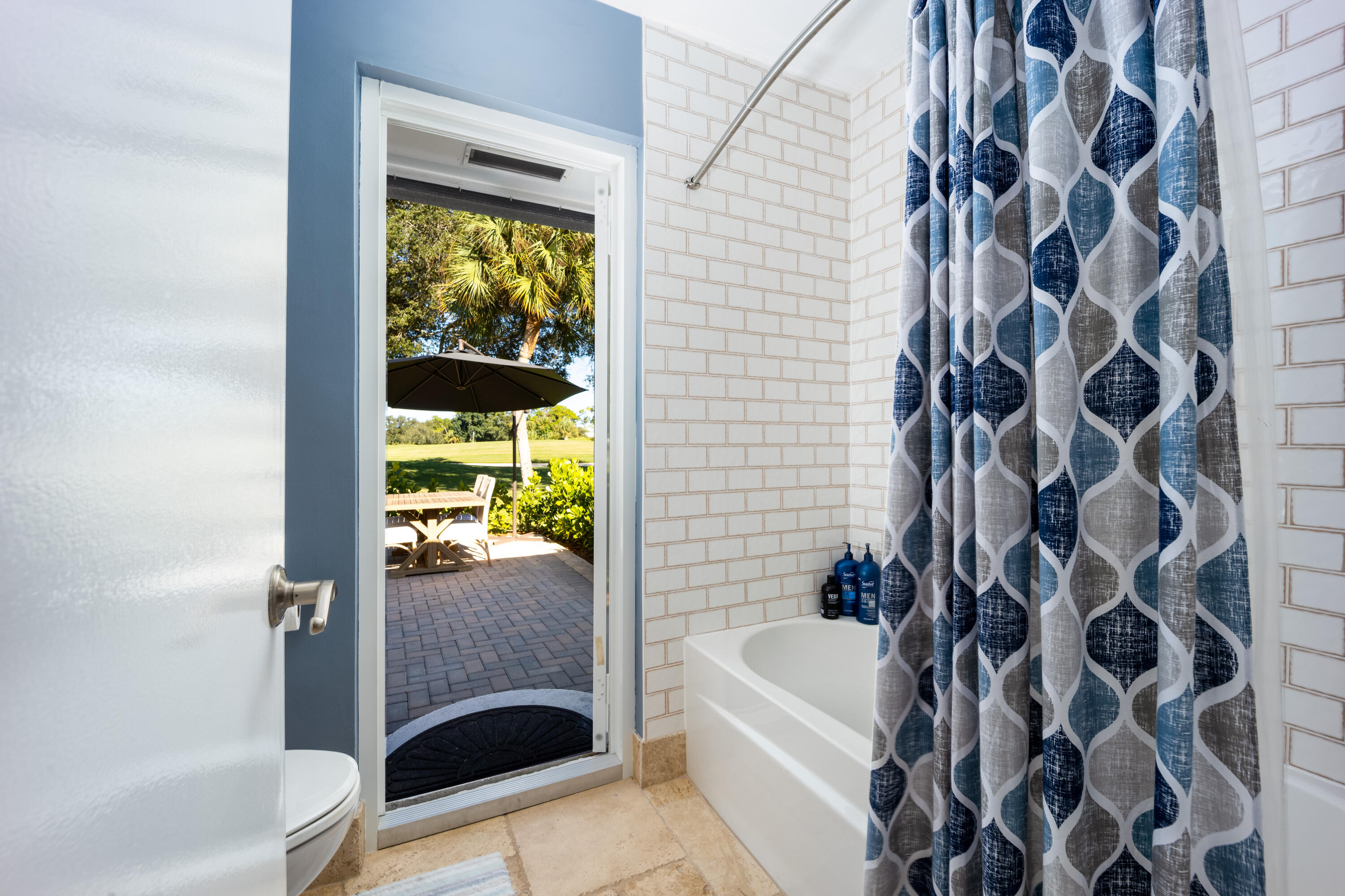 3771 Southeast Fairway West Stuart, FL 34997 - Photo 29 of 41 a bathroom with a bathtub and a shower