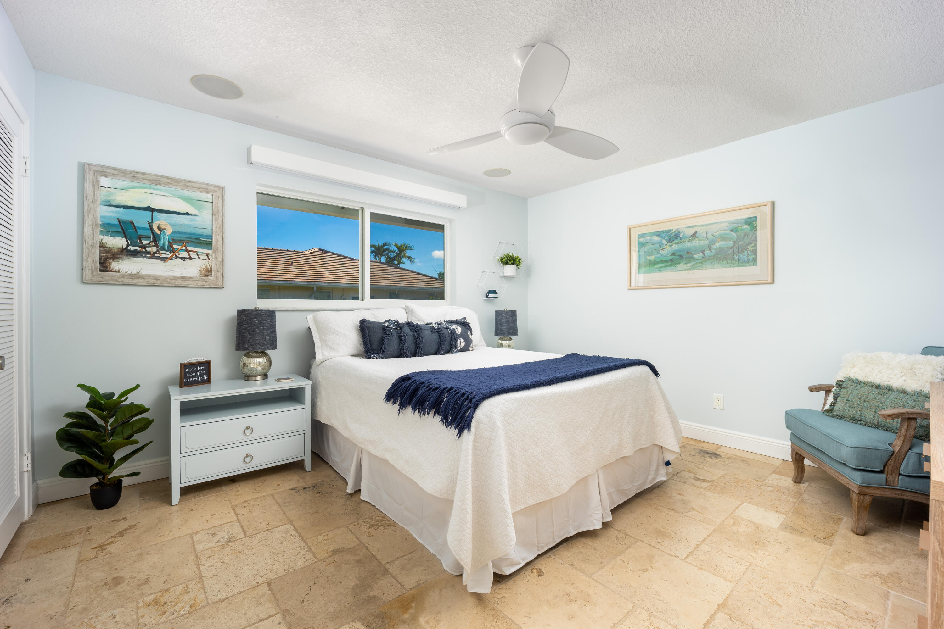 3771 Southeast Fairway West Stuart, FL 34997 - Photo 30 of 41 a bedroom with a bed and a chandelier