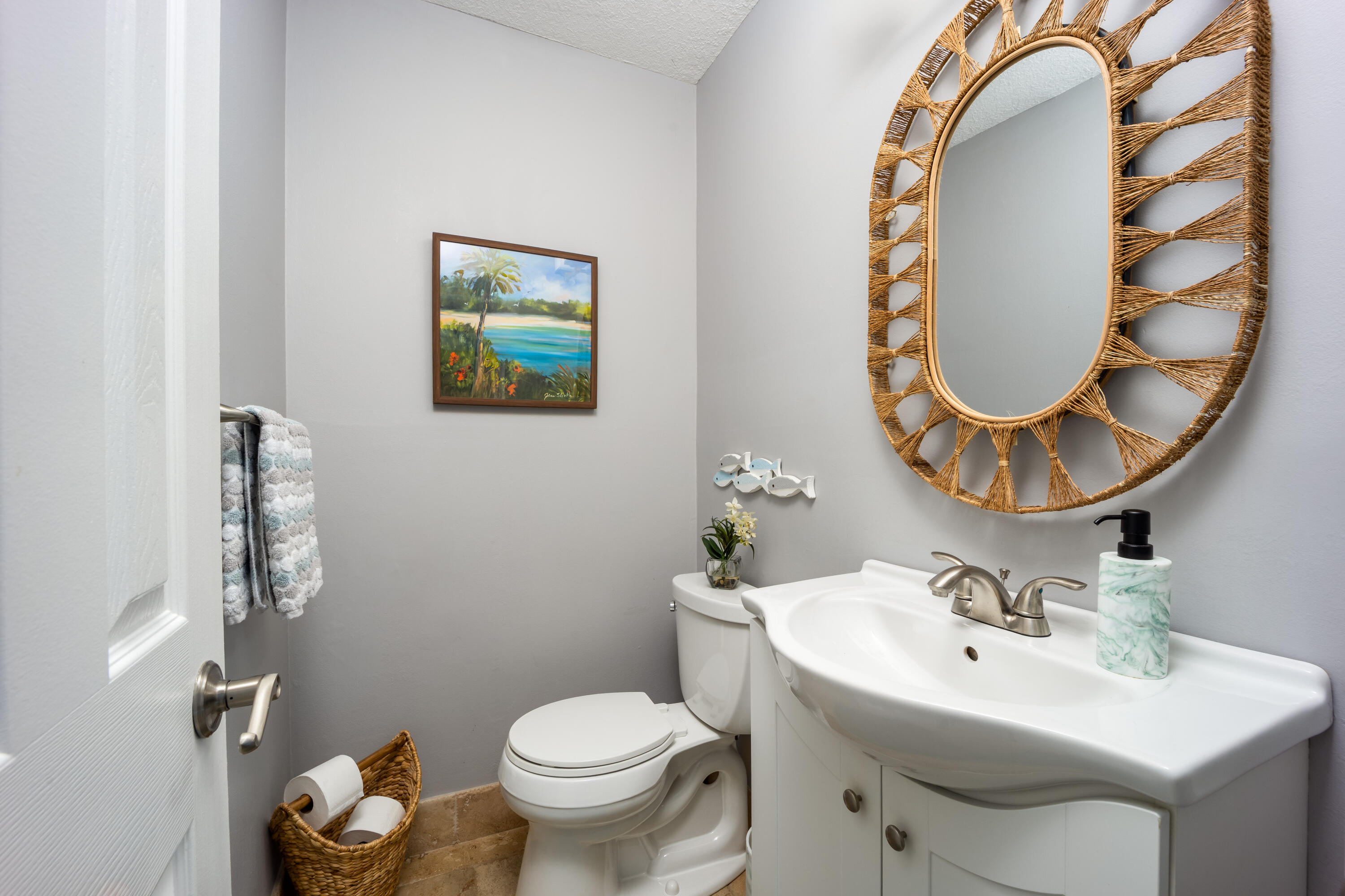 3771 Southeast Fairway West Stuart, FL 34997 - Photo 31 of 41 a bathroom with a toilet sink and mirror