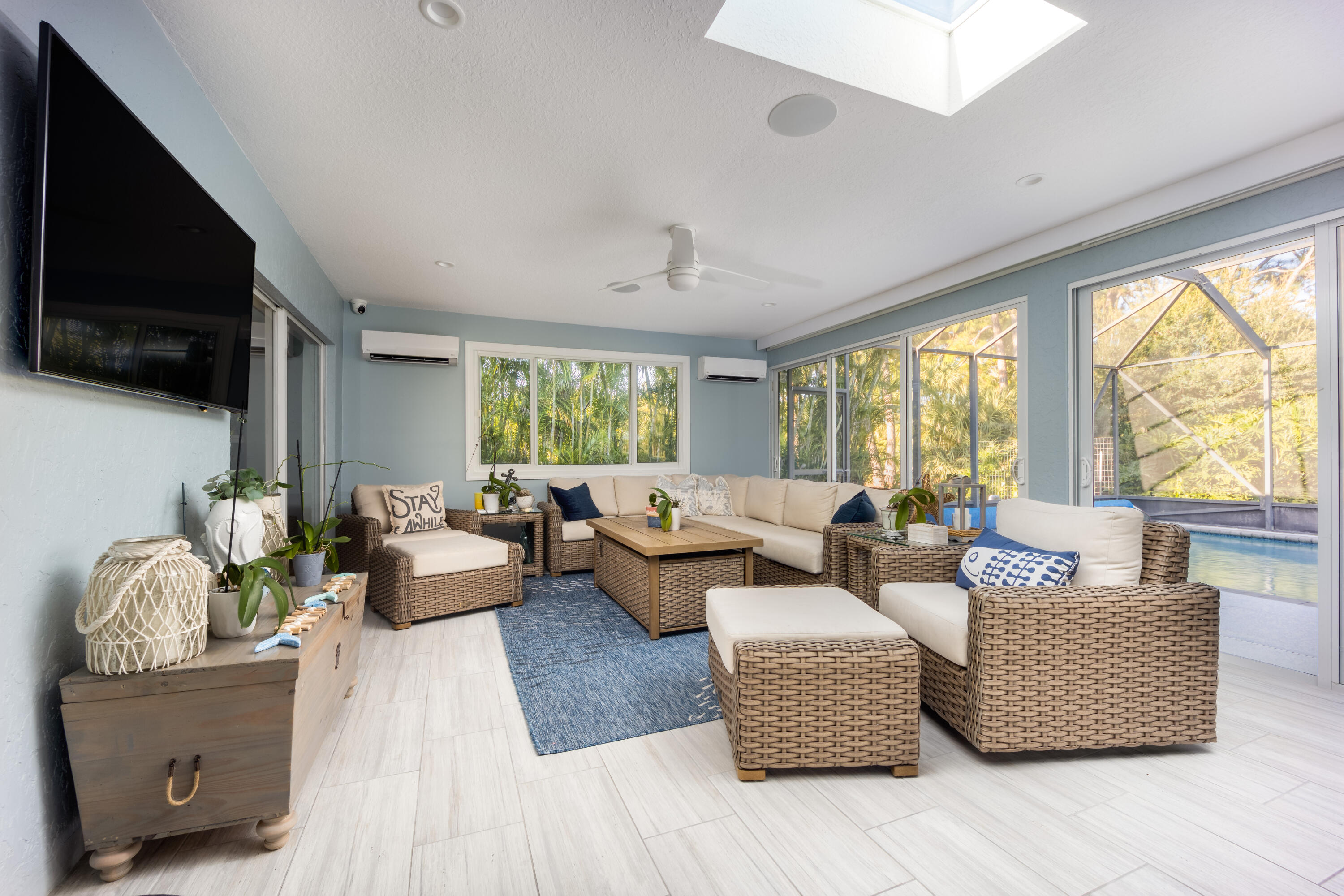 3771 Southeast Fairway West Stuart, FL 34997 - Photo 34 of 41 a living room with furniture and a flat screen tv