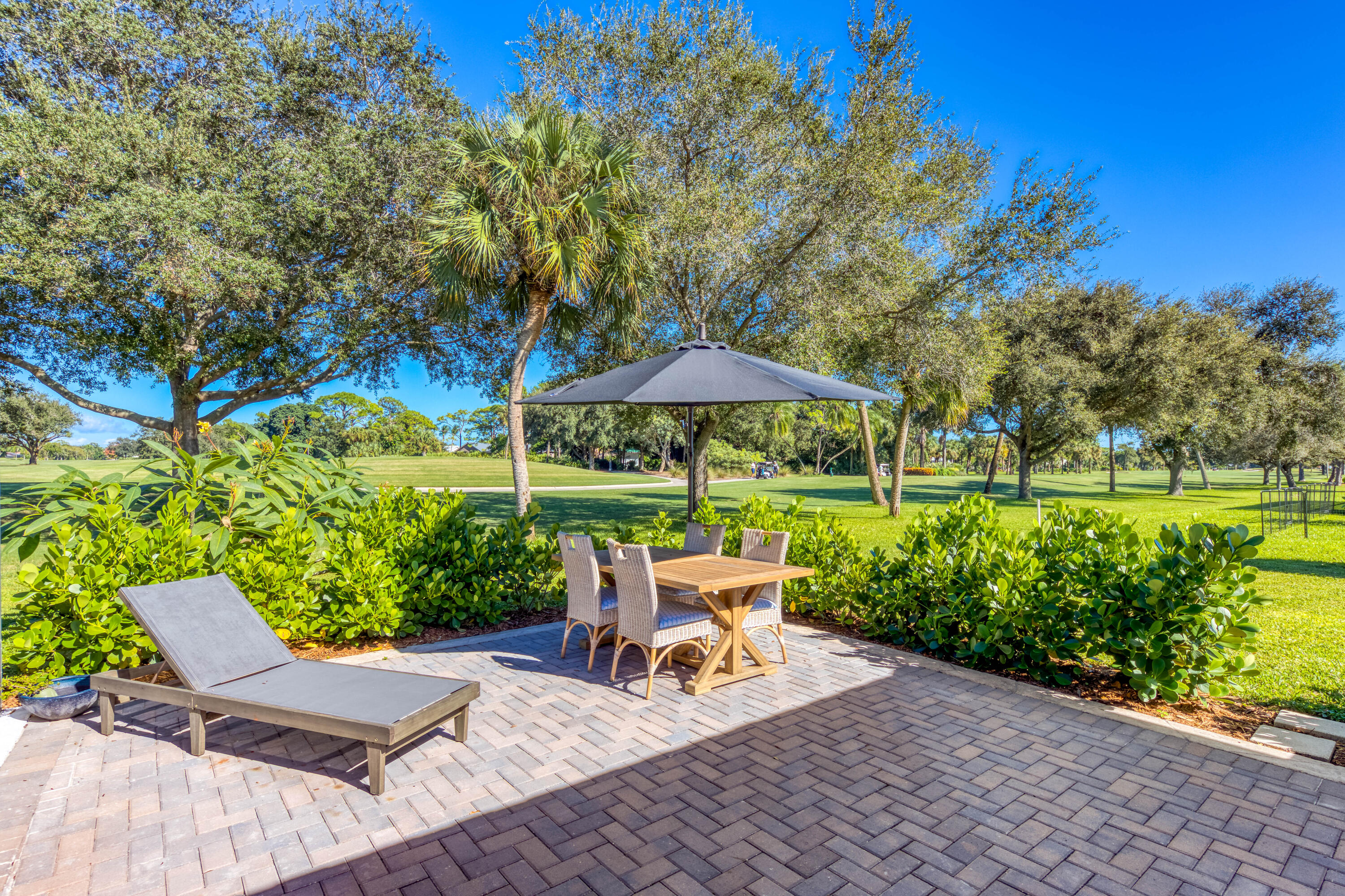 3771 Southeast Fairway West Stuart, FL 34997 - Photo 38 of 41 a view of backyard with outdoor seating and green space