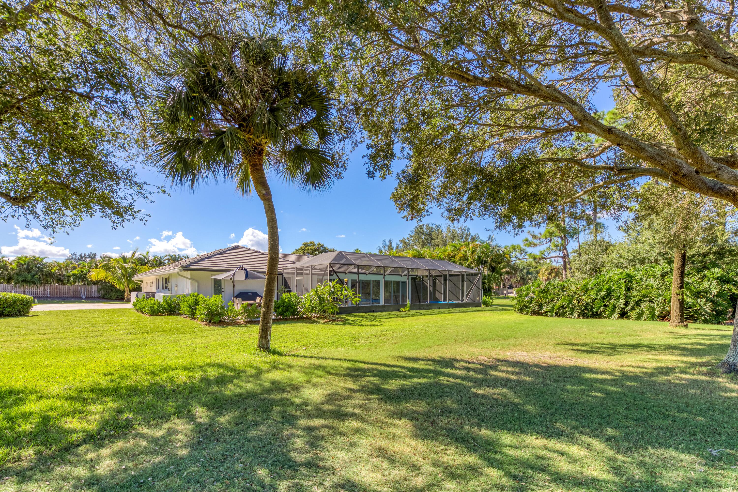 3771 Southeast Fairway West Stuart, FL 34997 - Photo 39 of 41 a view of a house with a big yard