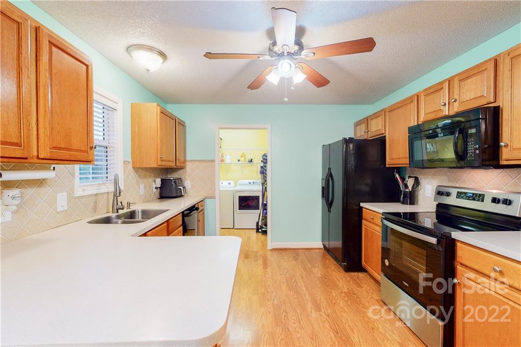 261 Pitts Road Catawba, SC 29704 - Photo 12 of 43 a kitchen with a stove a sink and a refrigerator