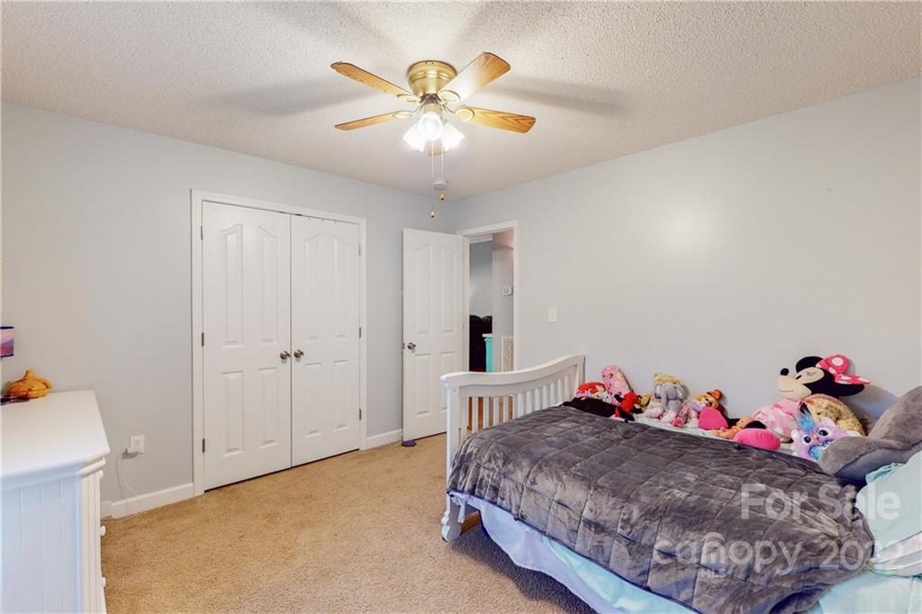 261 Pitts Road Catawba, SC 29704 - Photo 21 of 43 a bedroom with a bed and a chandelier