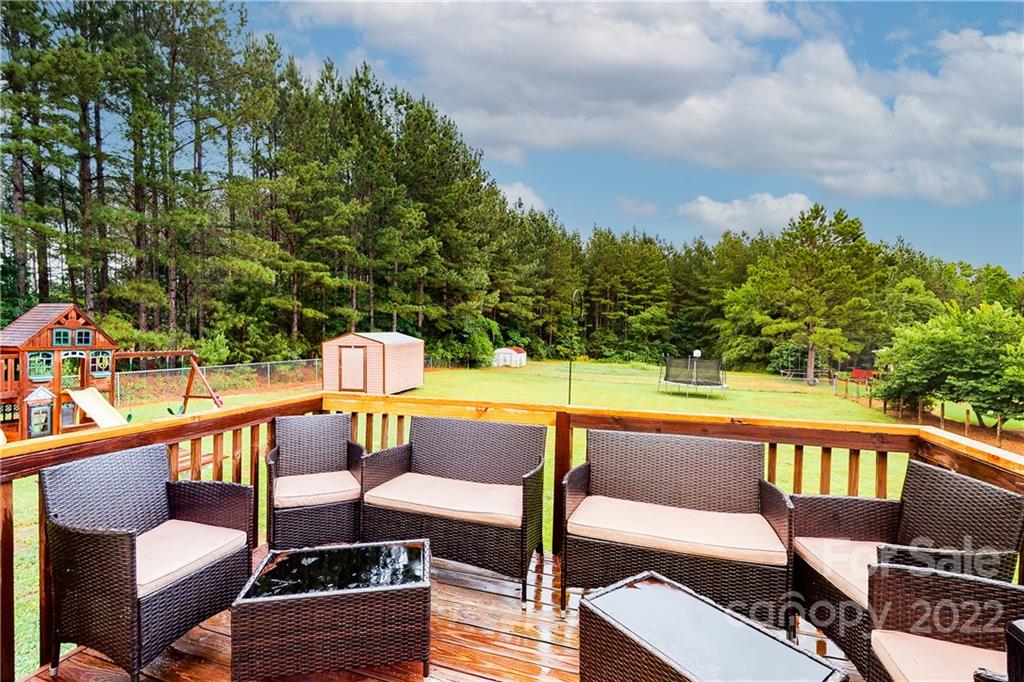 261 Pitts Road Catawba, SC 29704 - Photo 31 of 43 a balcony with wooden floor and outdoor seating