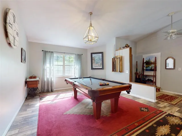 a living room with furniture a fireplace and a chandelier