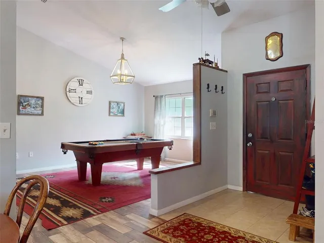 a view of a dining hall with furniture and wooden floor
