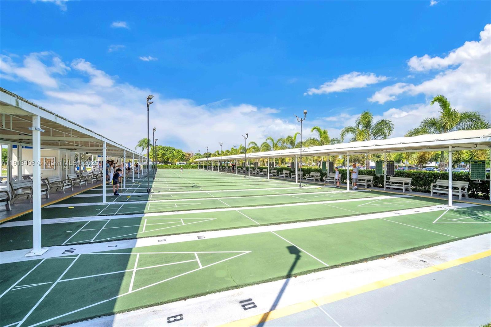 2048 Hythe A, Unit 2048 Boca Raton, FL 33434 - Photo 19 of 25 a view of a tennis ground with large trees