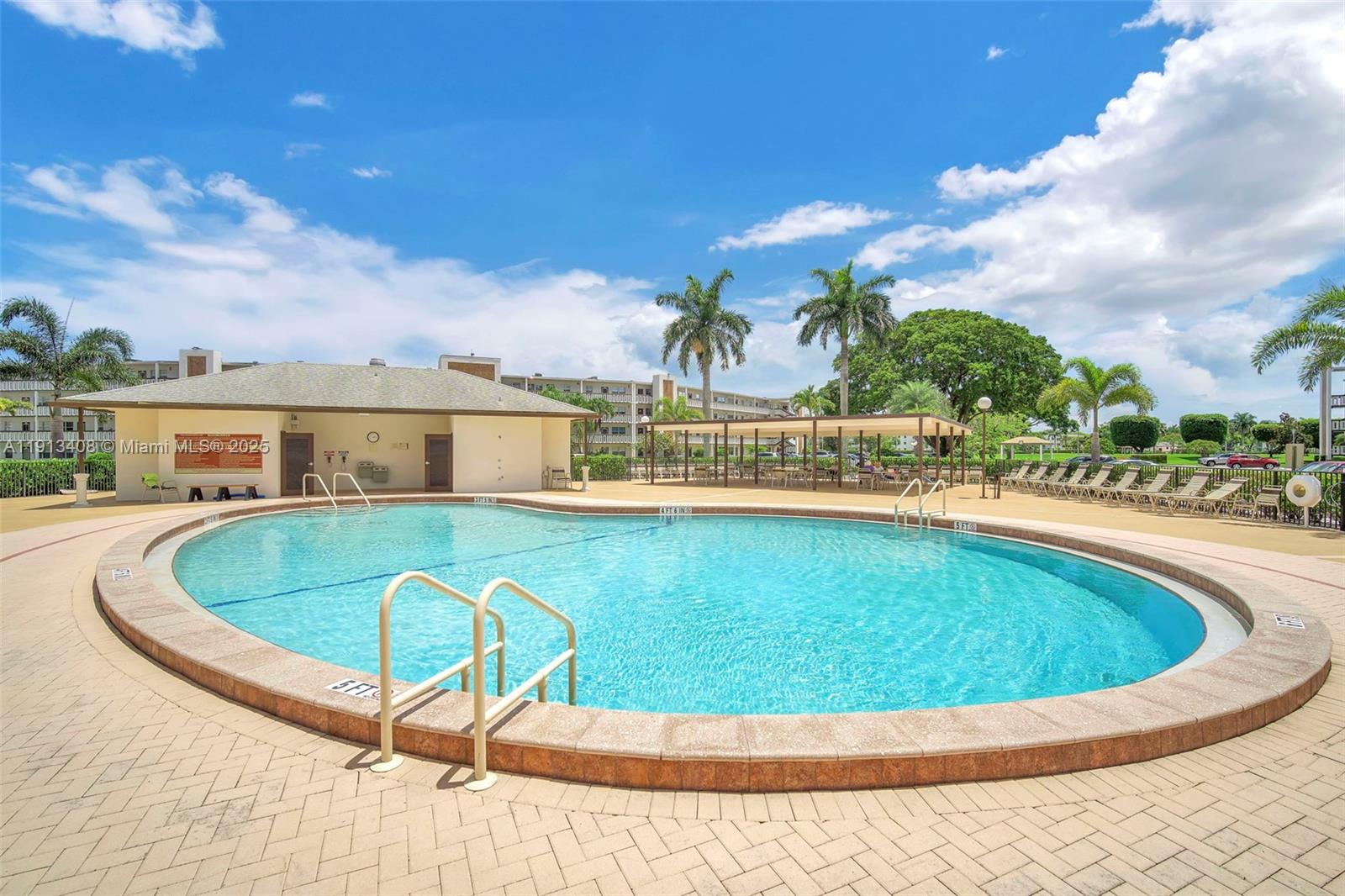 2048 Hythe A, Unit 2048 Boca Raton, FL 33434 - Photo 22 of 25 a view of a swimming pool with an outdoor seating and a yard