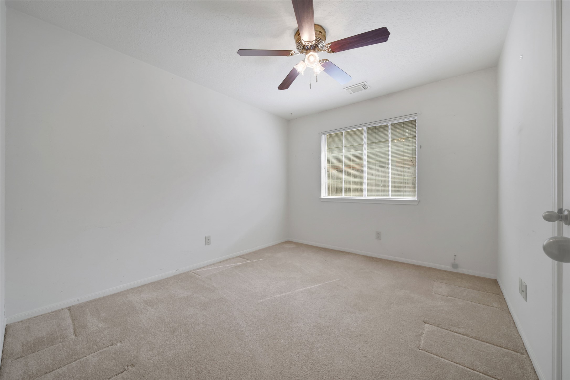 19110 Timber Way Drive Humble, TX 77346 - Photo 19 of 24 an empty room with a window and a fan