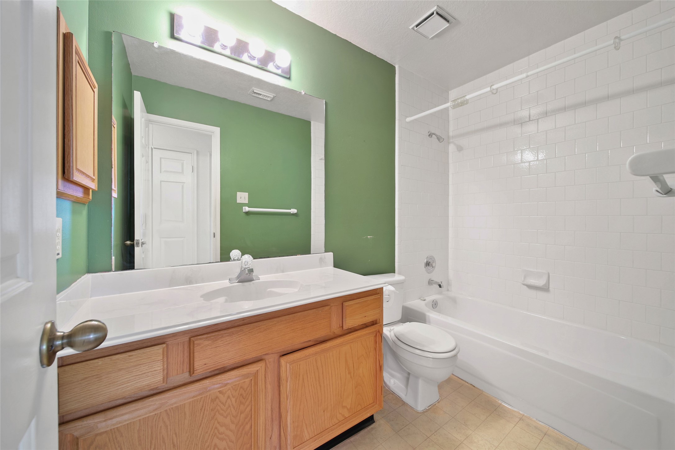 19110 Timber Way Drive Humble, TX 77346 - Photo 20 of 24 a bathroom with a granite countertop sink toilet a large mirror a bathtub and shower