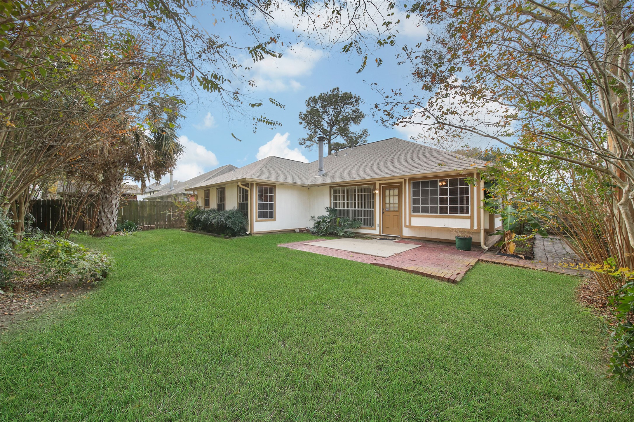 19110 Timber Way Drive Humble, TX 77346 - Photo 2 of 24 a front view of a house with a yard and trees