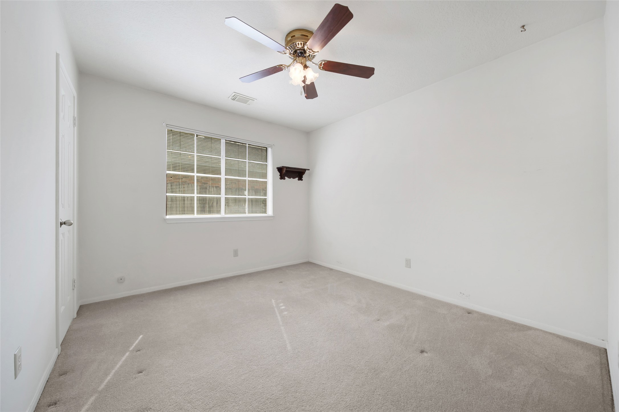 19110 Timber Way Drive Humble, TX 77346 - Photo 21 of 24 an empty room with windows and ceiling fan