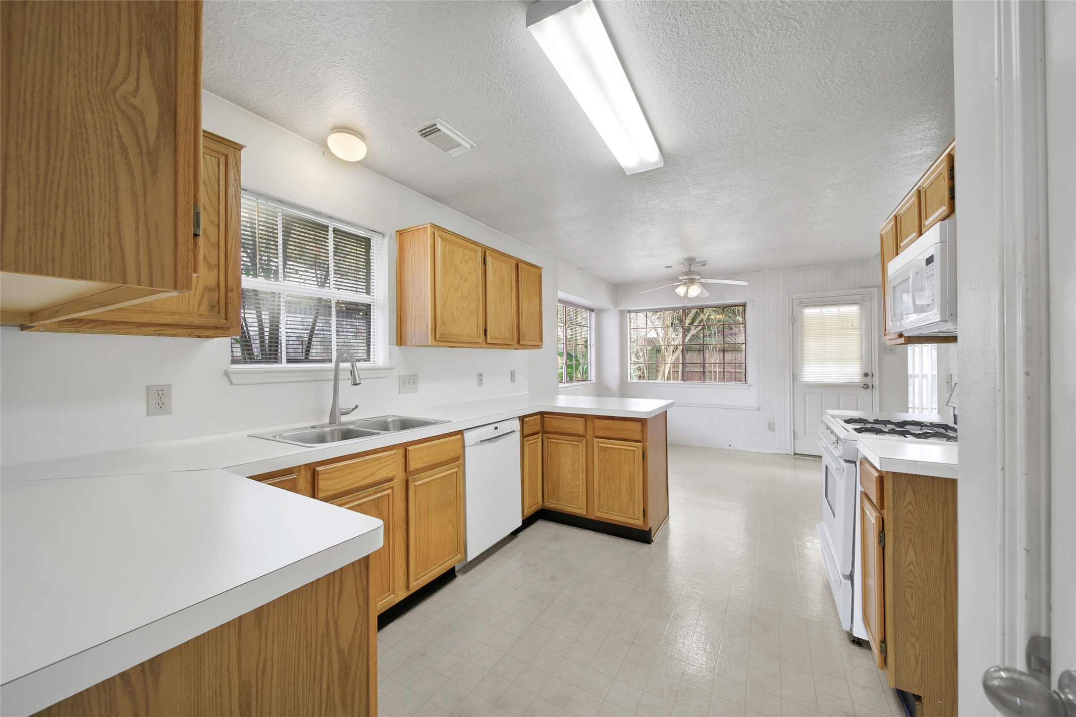 19110 Timber Way Drive Humble, TX 77346 - Photo 3 of 24 a kitchen with stainless steel appliances granite countertop a sink stove and refrigerator
