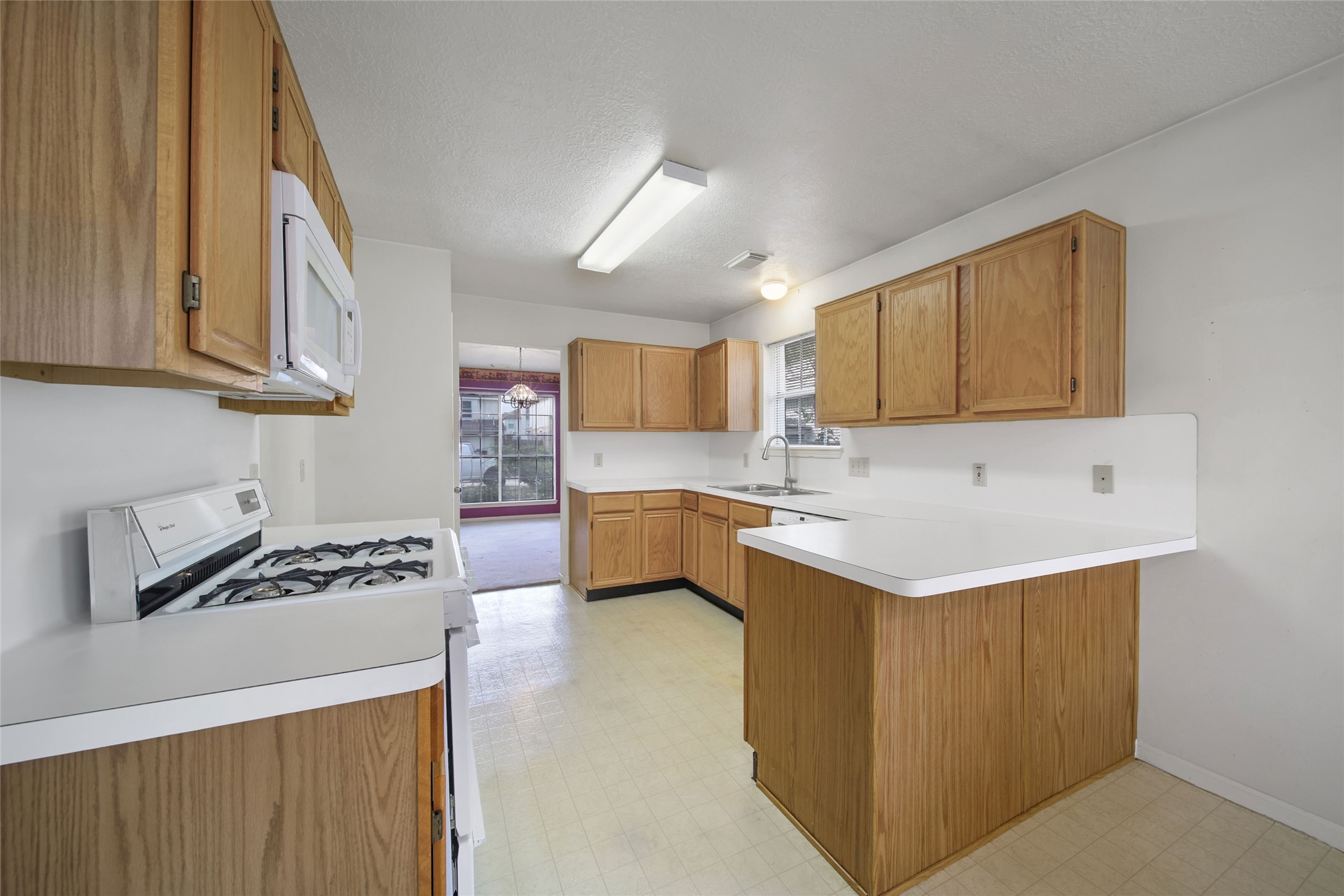 19110 Timber Way Drive Humble, TX 77346 - Photo 4 of 24 a kitchen with granite countertop a sink cabinets and window