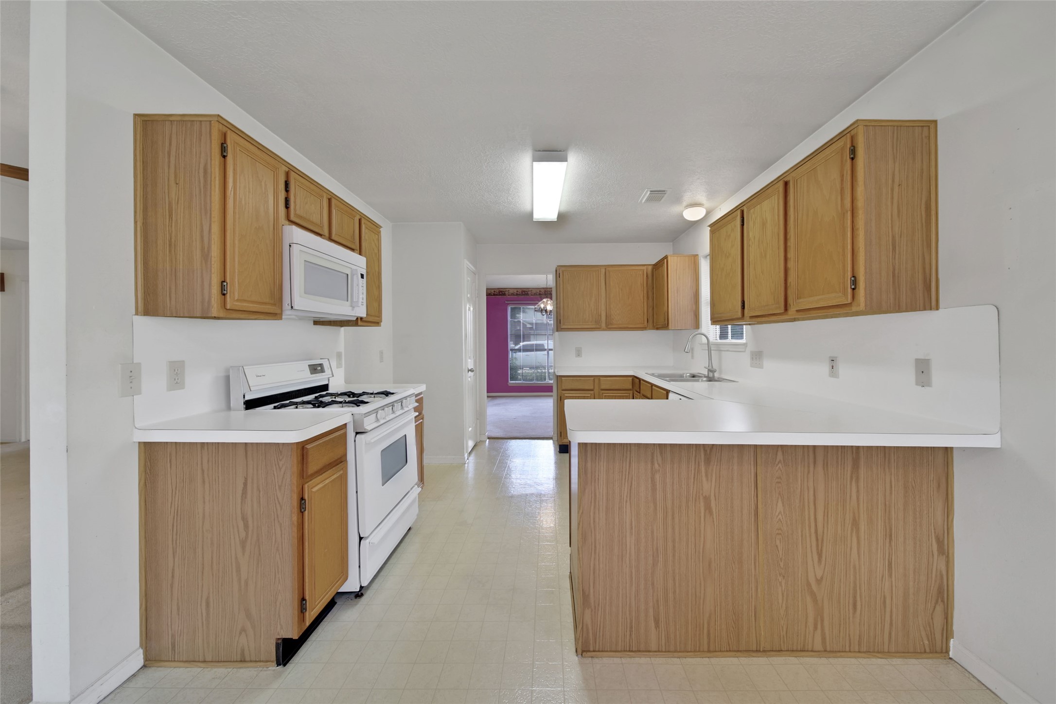 19110 Timber Way Drive Humble, TX 77346 - Photo 5 of 24 a kitchen with stainless steel appliances granite countertop a stove top oven a sink a refrigerator and white cabinets with wooden floor